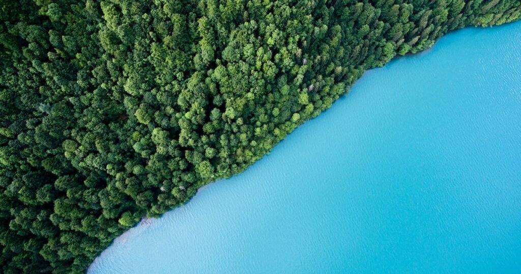 A white luxury yacht sailing on deep blue ocean water under a clear sky