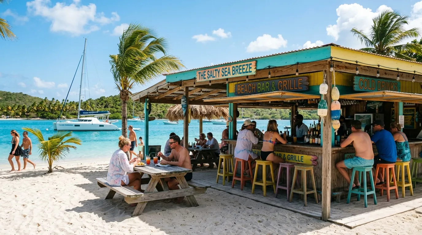 Casual beach bar on a BVI island with catamaran anchored in turquoise waters