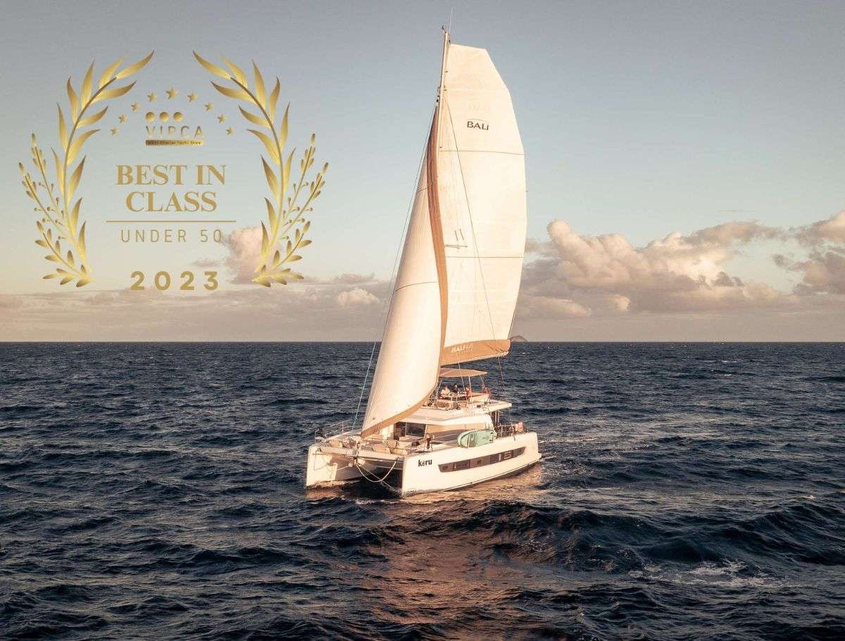 White sailboat on dark blue sea with a gold 'Best in Class Under 50 2023' laurel badge overlaying the image (award emphasis).