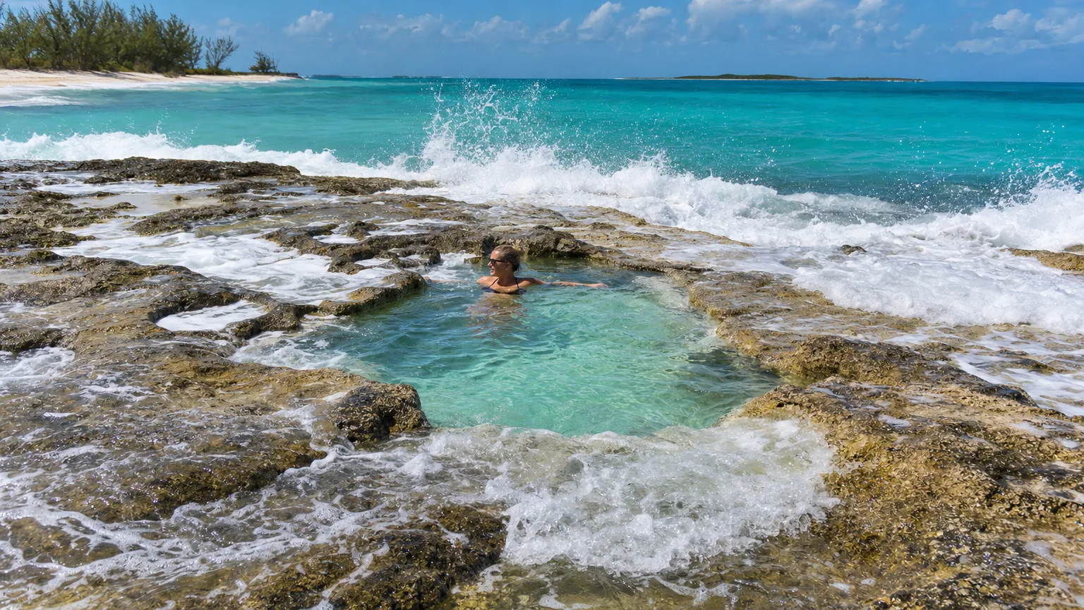 Rachel's Bubble Bath, a rock-rimmed natural tidal pool foaming with seawater on Compass Cay