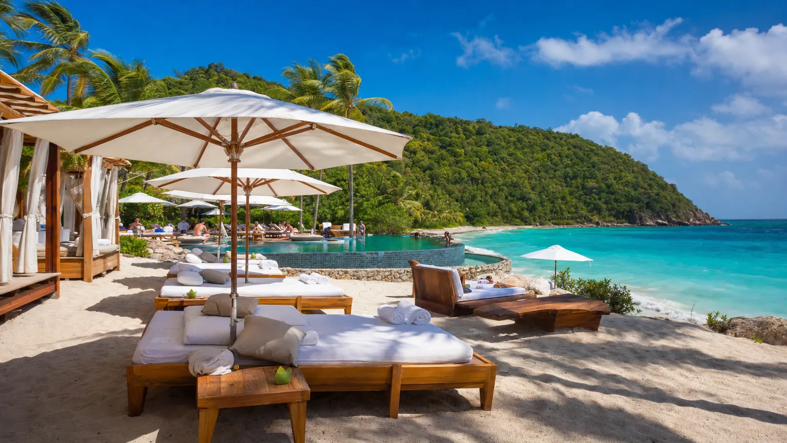Chic beach club cabanas and daybeds on a turquoise Caribbean shoreline with an infinity pool
