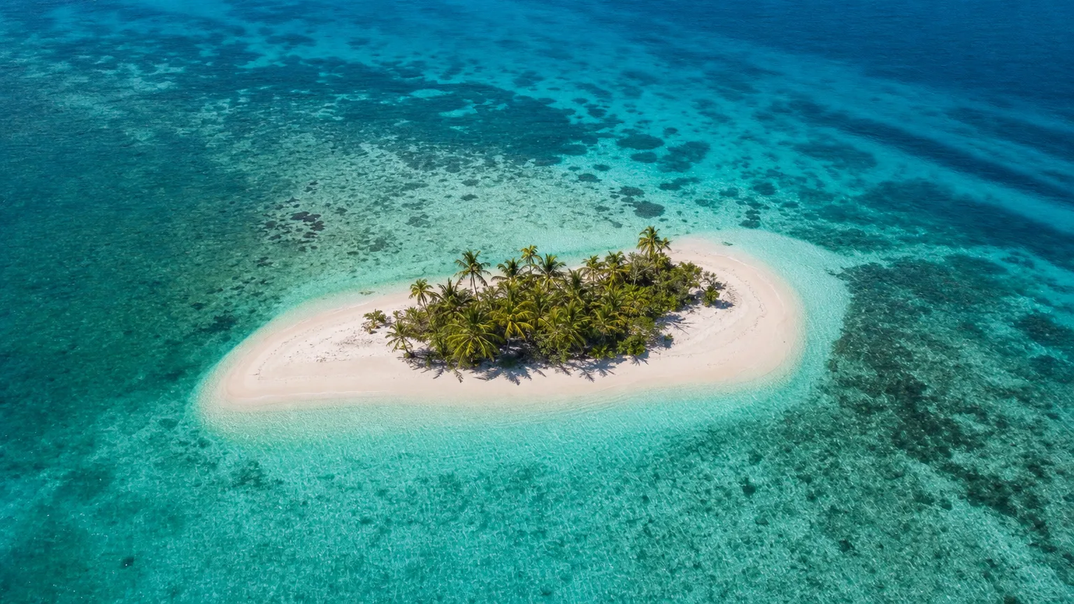 Aerial view of Sandy Island, Anguilla — a small palm-topped sandbar in turquoise water