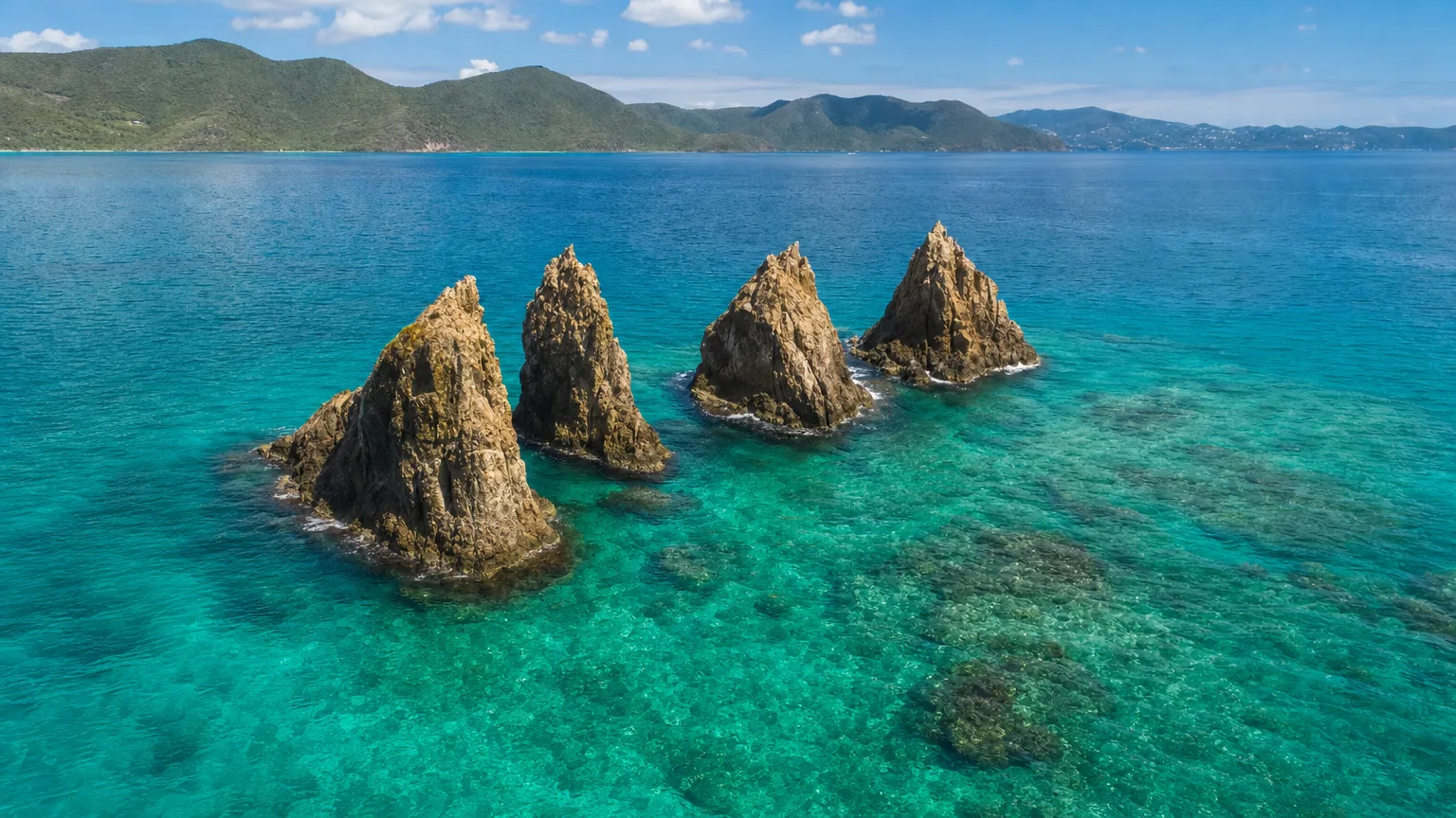 The four rocky pinnacles of The Indians rising from the turquoise sea off Norman Island, BVI