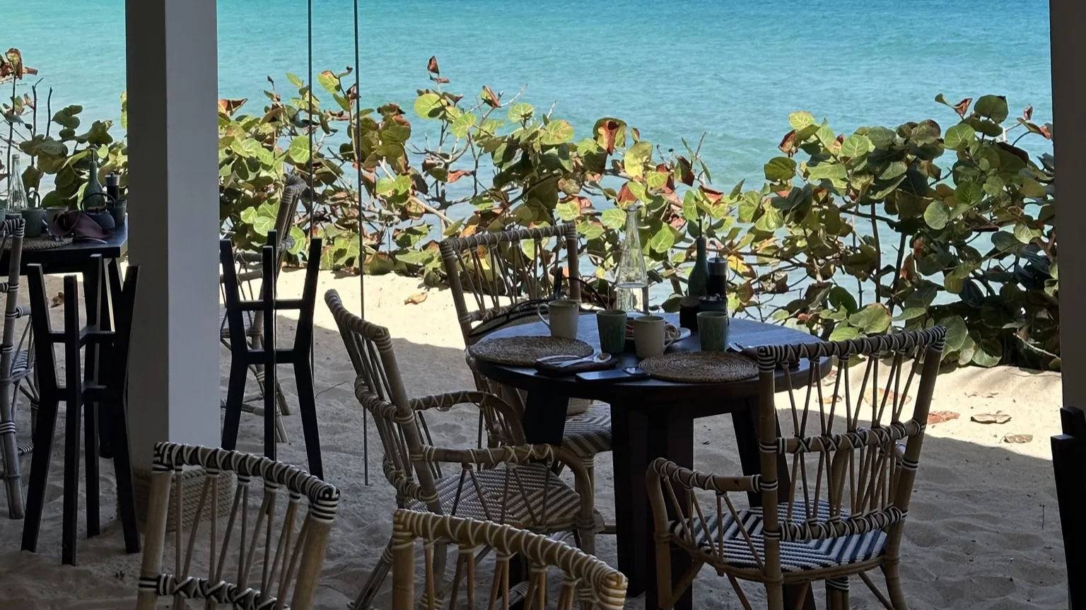 Beachside tables set on the sand at La Cabane, the seaside restaurant at Cheval Blanc St-Barth
