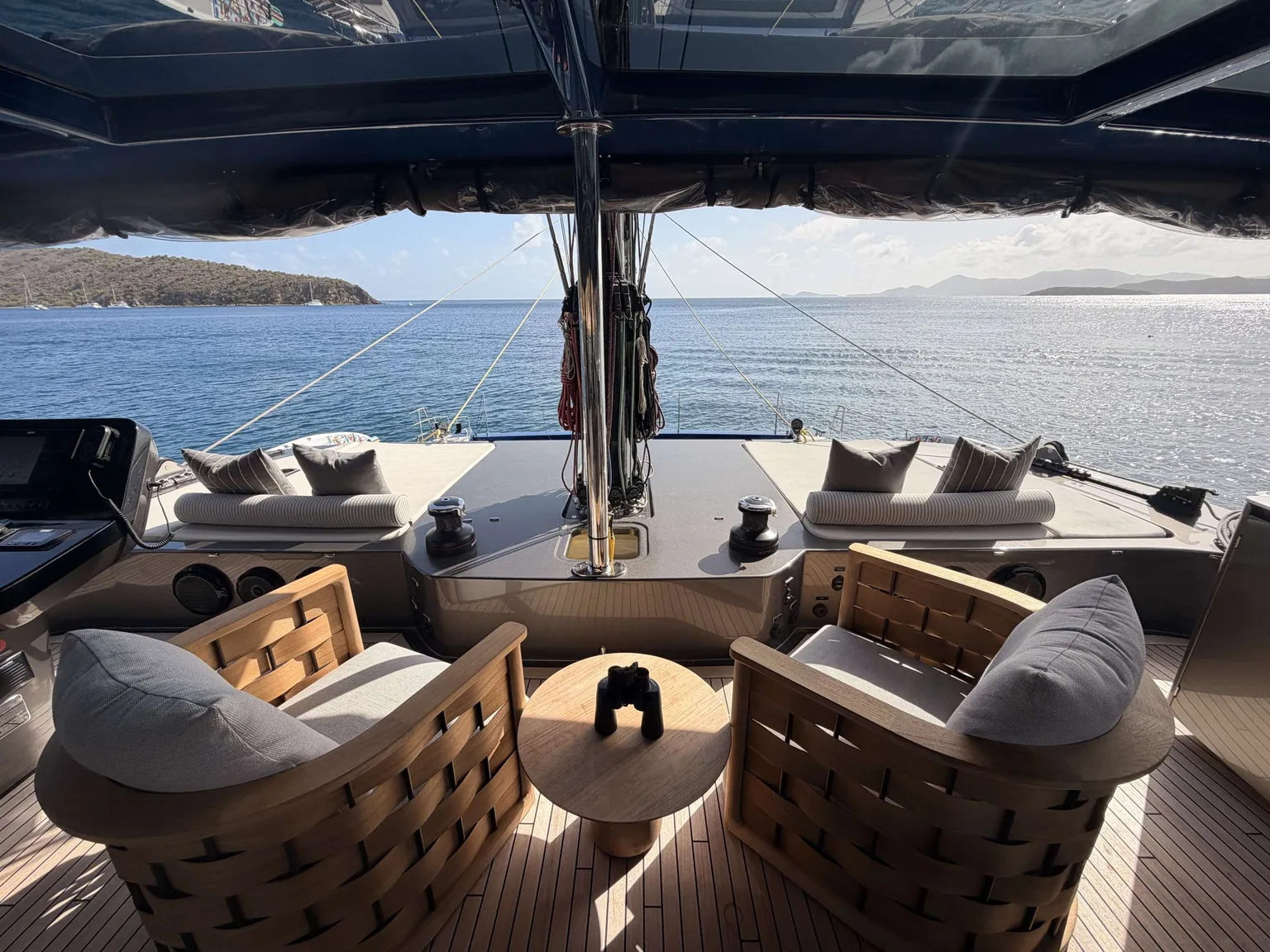 Flybridge lounge and helm aboard Encore overlooking a Caribbean anchorage