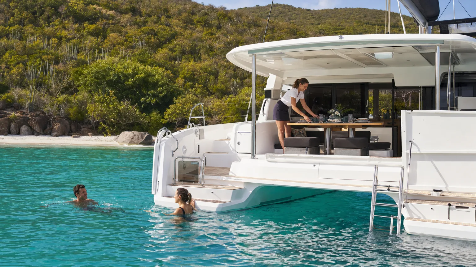 Guests dining aboard an all-inclusive charter catamaran anchored in the British Virgin Islands