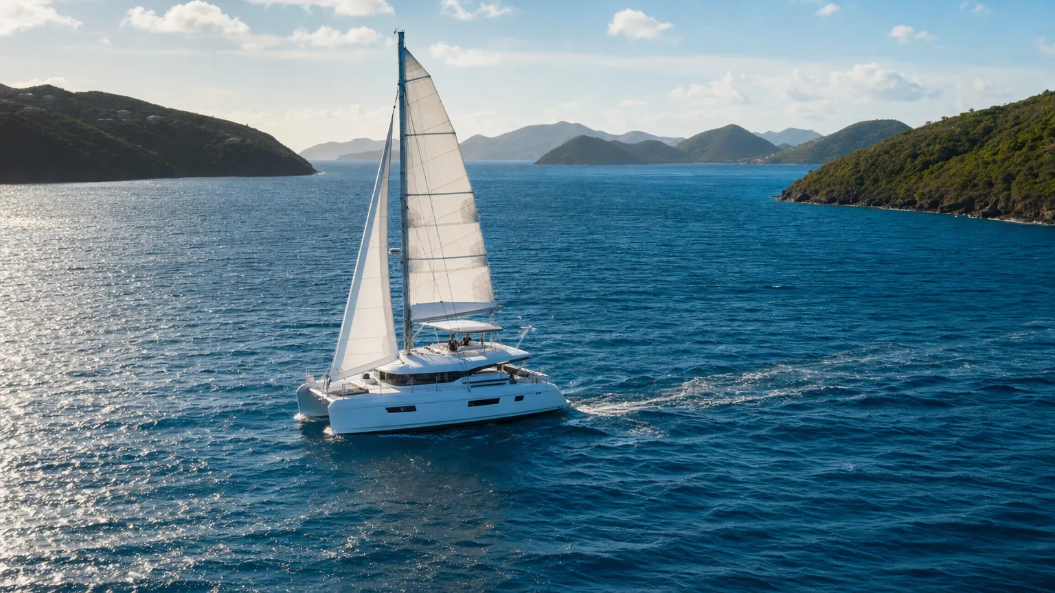 Catamaran under sail in the channel between British Virgin Islands on a trade wind afternoon