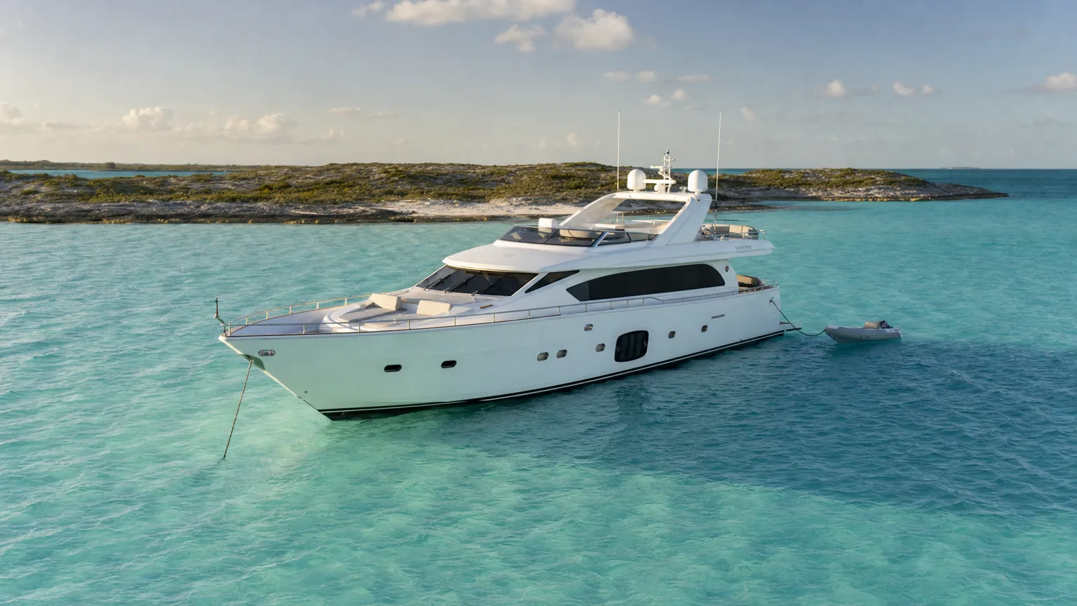 featured-image | Vital Charters Crewed motor yacht anchored over pale turquoise sand flats in the Exuma Cays, Bahamas