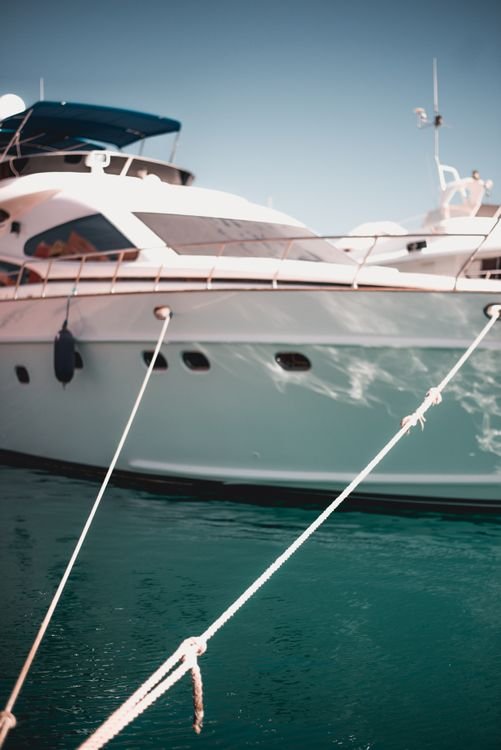 Crewed charter yacht at anchor in clear water, the setting where guests tip yacht crew at week's end