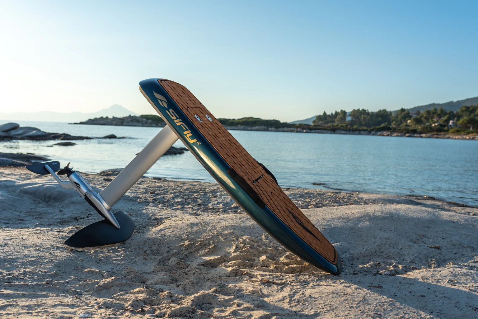 SiFly eFoil resting on a beach, showing the board, mast, hydrofoil wing and electric motor