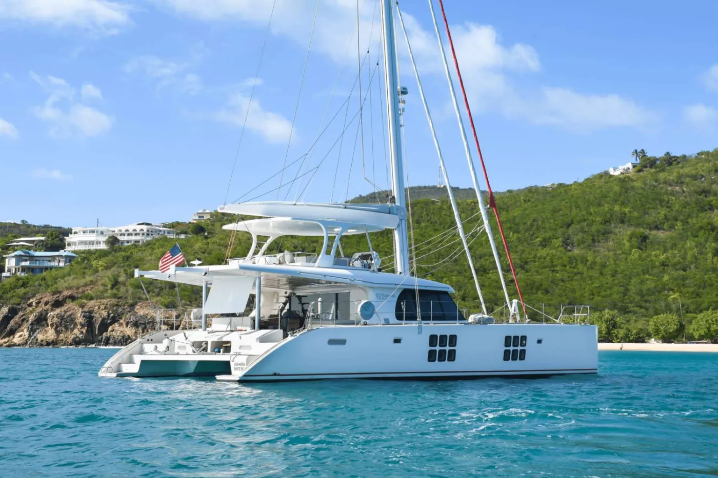 EUPHORIA is a 2016 60’ Sunreef Yachts sailing catamaran that delivers true luxury charter comfort with a sleek, modern feel. Sleeps 6 in 3 Queen cabins: a spacious Master Queen with an oversized, spa-like bath and two Queen cabins—each with a private ensuite. All cabins feature individual A/C controls for hotel-level comfort at sea. Standout feature: multiple inviting spaces to spread out—an airy salon for lounging or dining, an aft deck set for open-air meals for six, and top-deck seating with a lounge just forward of the helm for cocktails in the trade winds. Effortless flow, refined finishes, and the kind of comfort that keeps guests saying “wow” all week. EUPHORIA makes every moment feel elevated—easy, elegant, unforgettable.