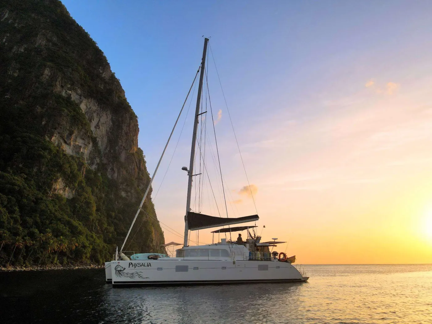 S/V Physalia, crewed and operated by her owners Chris and Kaya.
Masters level marine scientists, Chris & Kaya can offer your clients a deep immersion into the ocean world, each of them able to engage in discussion on any point of curiosity about the ocean, geology, and wildlife that abound in the Virgin Islands.
They also cater to specialty water sports including kitesurfing and wing-foiling support, as well as onboard SCUBA diving with diving instruction available.
Possibly unique to Physalia, they even have a 15’ double/single scull crew-style row boat on-board in addition to their normal dinghy.
They love treating their guests to out of the way anchorages, scenic naturalist guided hikes, fishing, free diving, paddle boarding, and kayaking. Their top-notch culinary offerings feature local ingredients and cuisines from around the world and have gotten rave reviews.
The third member of the crew and official ship’s ambassador is a very well-behaved and well-trained local pup named Waldo who melts hearts everywhere he goes. Please consider them for your clients, they won’t be disappointed!