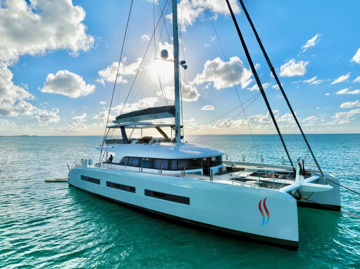 Twin Flame 77 is the latest Lagoon Seventy 7 offering the ultimate in luxury travel on the sea.

The interior has a layout optimized  for space and comfort.  The salon is bright, comfortable and roomy and opens not only to the aft cockpit but also directly to the forward cockpit for seamless movement around the yacht.  There is a massive flybridge affording an uncompromising 360* view. 

Twin Flame 77  has luxury accommodations for eight guests in a master stateroom with seating area.  There are 3 additional queen cabins that are elegantly appointed.  For additional flexibility, one cabin can be converted from a queen bed into 2 individual berths.  


2019 Award Winning Yacht & Crew: BVI Annual Charter Yacht Show - Best Yacht Overall
