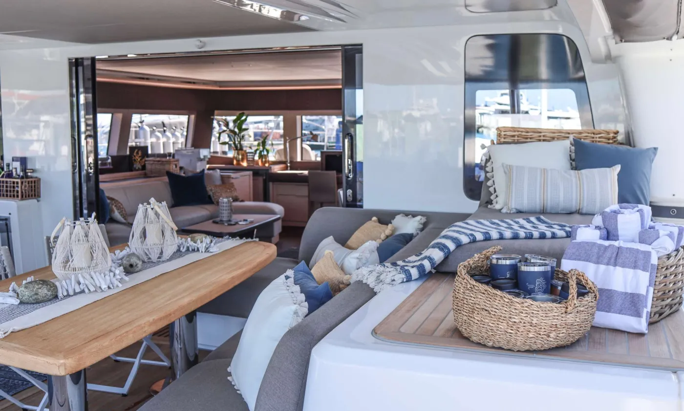 XANDROS - "The Defender of Mankind..."

Xandros is first Lagoon SIXTY5 available for luxury charter vacation and the first of its kind to be present in and around North America.   The beautiful down-galley allows for masterful culinary creations to appear out of thin air, while preserving various selections of seating and dining areas around the vessel.   The completely redesigned Flybridge area highlights the future of yachting and sailing onboard catamarans with full bar, dining area, lounges and dual helms.  

The Experience onboard Xandros is meant to be the perfect mix of Luxury and Modern Adventure.  Three Crew are onboard to provide seamless service and guide the best vacation of your life.  All of today's top technology accompanies the vessel including Dive equipment, Dive Compressor, Seabob's, E-foil, watersports equipment, floating lounge, huge tender and more.

Come change your perspective with us on aboard Xandros... We're looking forward to your arrival.

With its slender hulls and sculptural curves, the Lagoon SIXTY 5 has rightly earned its place in the world of luxury sailing yachts. The secret of its beauty lies in the sensual lines. They are an alliance of both tradition and modernity that orchestrate its generous proportions.

On board the SIXTY 5, the flybridge is a key space that is accessed via wide, safe stairs. Electric sliding doors give the option of this space being fully enclosed as required. The SIXTY 5&rsquo;s flybridge is a beautifully appointed deck with two helm stations. One on each side, for clean, unobstructed views. The rigid bimini is fitted with see-through glass. It allows the skipper to keep an eye on the sails when they are hoisted up. The flybridge is home to a huge, comfortable and sleek looking sofa. You will also find spacious storage lockers underneath the sofa and a reclining backrest. A large dining table and another wet bar with a plancha grill, fridge and cutlery lockers, complete the picture.

When on board the Lagoon SIXTY 5, you can look straight through fore to aft and out over your surroundings with commanding 360&deg; views. Her elegant interior is by Nauta Design, and demonstrates the new signature &ldquo;Connect&rdquo; outfit from Nauta. The main saloon is comfortable and luxurious with open spaces and natural light. The same design concept has been applied to the guest cabins. They enjoy good overhead height and excellent natural light and views. The high level of finishing throughout every cabin reflects the luxury feel of the main saloon.

The bright and spacious saloon is located forward. It has a design palette that includes grey oak and beige upholstery for the sofas. A large dining table is positioned on the starboard side, with a u-shaped sofa and lounge area with a low coffee table on the port side. This first hull has a galley-down layout with four cabins. It delivers the massive main deck saloon space for guests to enjoy. From the saloon there is direct access to the foredeck terrace. This area offers features sofas, a coffee table and an optional canopy shade that can be installed on to stainless pillars. This space is also ideal for storing diving gear.