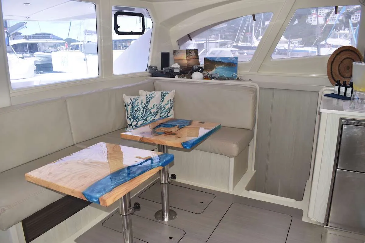 With an abundance of outdoor space, the spacious three double cabins and 3 ensuite bathrooms plus the large saloon and galley, Sol Seeker is both luxurious and practical - plenty of room for groups and families.
It's a family friendly boat. No age restrictions.
Sol Seeker had stunning new salon tables that were custom made by an artist and installed in November 2021. They are a unique feature that brings life and art to the space.
Sol Seeker features a walkthrough salon for the comfort and safety of guests. There is also a front seating area outside that is ideal for guests with mobility issues or younger children. They feel like they can still be out front in a safe way and included in the fun that happens on the trampoline instead of separated from the group. Actually most guests say this is one of their favorite spots on the boat.