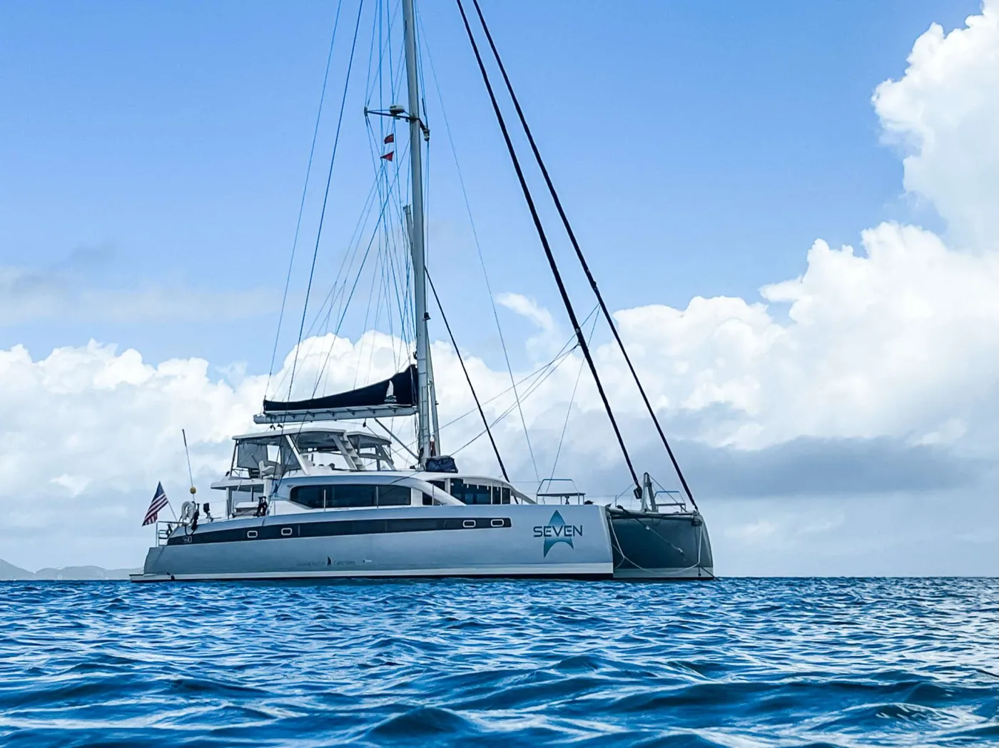 Experience luxury, adventure, and BVI bliss aboard SEVEN, a 2023 Voyage 590 sailing catamaran. With five equal queen cabins for up to 10 guests and four distinctive living and dining spaces, your group will have ample room on board to enjoy your time together or special quiet moments for two.

SEVEN&rsquo;s three-member crew of Captain, Chef, and Stewardess provide luxury service, meals, cocktails, and most importantly &ndash; lots of fun experiences! SEVEN is equipped for onboard scuba-diving, led by Captain James, a PADI-certified dive instructor. Plenty of water toys are available, and the fishermen onboard can try for a big catch while on passage.

Guests aboard SEVEN are sure to have a wonderful vacation, whether relaxing with family and friends or enjoying the watersports and adventures the BVI offers. With an attentive crew and spacious, comfortable layout, SEVEN is the perfect home on the water for your BVI charter!
