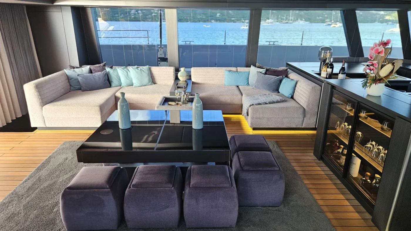 If you had to describe the Sunreef 80 SHADES OF GREY in one sentence, you would say that this Sunreef 80 impresses with its clean, elegant design and is truly no 'grey mouse'. Warm shades of grey, combined with a modern green, give the interior a fresh and very elegant look. You will immediately feel at home on board as there are no 'loud' design elements to obstruct the view and everything is simply harmonious.

The master cabin is located in the middle of the starboard side and has a king-size bed, a small sofa for relaxing, a dressing table and a walk-in wardrobe. The bathroom with shower is very spacious. Also to starboard is the double cabin (queen size bed) with a comfortable en suite bathroom.

On the port side, amidships, is the VIP cabin (queen-size bed), which is slightly larger than the double cabin and has a walk-in wardrobe. The bathroom is also slightly larger. Forward on the port side is the guest cabin with three comfortable single beds and an en-suite shower room. The beds are 80 x 200 cm and the bunk beds are staggered so that the upper bed is easy to reach.

The saloon is all about relaxing together, with two really big lounge sofas. In the centre is a black glass table that can be converted into a dining table for up to 10 people in bad weather.

The aft deck has a large dining table that can seat up to 10 people and a lounge sofa. There is also a lounge with a coffee table on the foredeck.

On the flybridge, the SHADES OF GREY has another large dining table, perfect for up to 10 guests, with a U-shaped seating area. Behind this is a full width sunbathing area. Forward of the helm position is an attractive bar, where you can enjoy a drink or have a snack from the chef.

The flybridge is transformed into a spa area when the stewardess sets up her massage table and pampers guests with a feel-good massage.

There is also a wide range of water sports on board, including an E-Foil, two Seabobs and numerous other water toys, as well as a water slide. And it's not just the kids who have fun! 