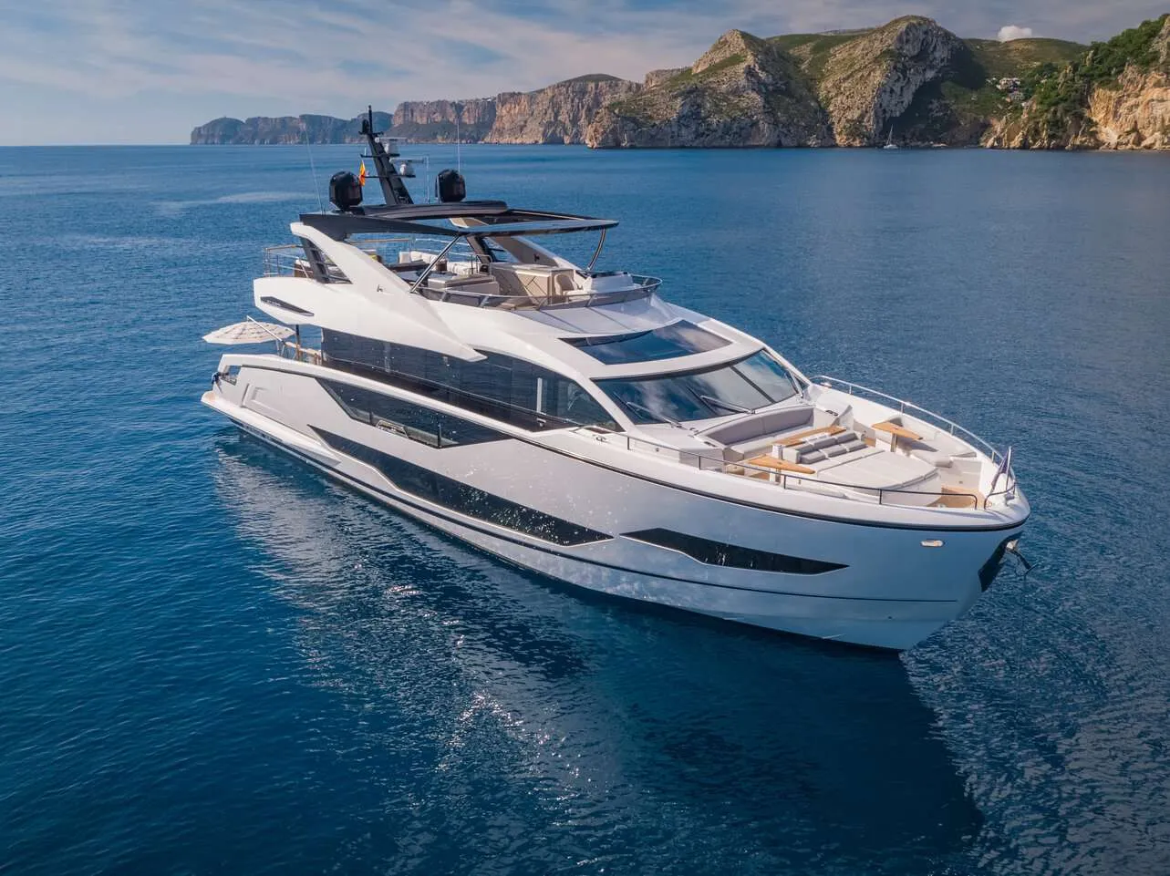 <p>Step aboard 1 LORENA, a stunning Sunseeker 90 Ocean that embodies modern luxury, open space, and effortless comfort. From the moment you enter the main salon, you’re greeted by massive, floor-to-ceiling windows that flood the space with natural light and offer sweeping ocean views. The open-plan design and elegant décor create a bright, inviting atmosphere which is perfect for relaxing with family or entertaining guests in refined comfort.</p>
<p>Below the helm station forward, you’ll find the VIP stateroom, accessed by its own private staircase. This beautifully appointed suite offers complete privacy and features an ensuite bath, making it an ideal retreat for guests. Midship, another staircase leads to the full-beam master stateroom, a true haven with a king-size bed, a cozy lounge area, and a luxurious ensuite bathroom. Completing the accommodations are two additional guest cabins — one convertible twin cabin that can transform into a double bed, and one fixed queen cabin. Altogether, 1 LORENA comfortably sleeps up to eight guests in four stylish staterooms.</p>
<p>Outdoor living is where 1 LORENA truly shines. The aft deck offers a flexible lounging area, where the chairs can easily swivel to face aft, perfect for enjoying a drink while watching the sun dip below the horizon. The expansive hydraulic swim platform provides seamless access to the water, ideal for launching water toys or taking a refreshing dip.</p>
<p>Forward, the bow lounge offers an inviting space to unwind with plush sunpads and seating, a favorite spot for morning coffee or sunset views. The flybridge is equally impressive, featuring al fresco dining, a wet bar, and panoramic views that set the stage for unforgettable moments at sea.</p>
<p>Whether you’re cruising island to island or anchored in a secluded bay, 1 LORENA delivers the perfect balance of elegance, comfort, and adventure for an exceptional charter experience.</p>